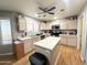 Spacious kitchen features stainless appliances, a center island, and wood-look flooring at 1636 E Marigold St, Casa Grande, AZ 85122