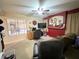 Bright living room with neutral carpet, a ceiling fan, and comfortable seating, creating a relaxing atmosphere at 1636 E Marigold St, Casa Grande, AZ 85122