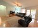 A spacious living room featuring plush leather seating, ceiling fan and wood flooring at 1636 E Marigold St, Casa Grande, AZ 85122