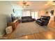 Spacious living room features plush seating, ceiling fan, and wood-look flooring at 1636 E Marigold St, Casa Grande, AZ 85122