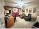 Cozy living room with neutral carpet, a ceiling fan, and a desk with a computer for work or study at 1636 E Marigold St, Casa Grande, AZ 85122