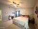 Comfortable bedroom with a ceiling fan, neutral walls, and a window offering soft, natural lighting at 1636 E Marigold St, Casa Grande, AZ 85122