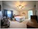 Spacious main bedroom with a ceiling fan, plush carpeting, and a large window for natural light at 1636 E Marigold St, Casa Grande, AZ 85122