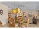 Bright dining area adjacent to the living room with glass table, rattan chairs, and pendant lighting at 1651 E Kielly Ln, Casa Grande, AZ 85122