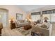 Cozy living room features tile floors, two sofas, area rug, and lots of natural light at 1651 E Kielly Ln, Casa Grande, AZ 85122