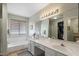 Bright main bathroom featuring double sinks, a soaking tub, and a walk-in closet at 1651 E Kielly Ln, Casa Grande, AZ 85122