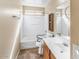 Bathroom featuring a combination tub and shower, a single sink vanity, tile flooring and accessible grab bars at 1655 W Wilson Ave, Coolidge, AZ 85128