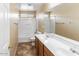 Bright bathroom showcasing a double sink vanity and a shower-over-tub combination at 1655 W Wilson Ave, Coolidge, AZ 85128