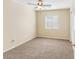 Neutral bedroom with beige carpet, a ceiling fan, one window and baseboard trim at 1655 W Wilson Ave, Coolidge, AZ 85128