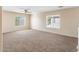 Spacious bedroom featuring carpeted floors, a ceiling fan and two large windows for ample light at 1655 W Wilson Ave, Coolidge, AZ 85128