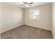 Neutral bedroom featuring a ceiling fan, window and plush carpet, naturally illuminated at 1655 W Wilson Ave, Coolidge, AZ 85128