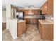 Well-lit kitchen features wood cabinets, stainless steel appliances, tile backsplash and tile floors at 1655 W Wilson Ave, Coolidge, AZ 85128