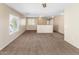 Spacious carpeted living room featuring large windows and neutral-colored walls at 1655 W Wilson Ave, Coolidge, AZ 85128