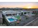 Aerial view showcasing a backyard oasis with a pool, spa, and artificial turf at 18024 E Wolf Tree Ln, Rio Verde, AZ 85263