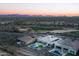 Aerial view of luxury homes with pools in a golf course community with picturesque mountain views at 18024 E Wolf Tree Ln, Rio Verde, AZ 85263