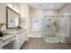 Luxurious bathroom featuring dual vanity sinks, granite counters, and a spacious glass shower enclosure at 18024 E Wolf Tree Ln, Rio Verde, AZ 85263