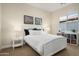 Cozy bedroom with neutral walls, window, and a comfortable bed with white bedding, plus matching bedside tables at 18024 E Wolf Tree Ln, Rio Verde, AZ 85263