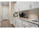 Well-organized butler pantry with white cabinetry, granite countertops, and stainless steel appliances for convenience at 18024 E Wolf Tree Ln, Rio Verde, AZ 85263