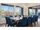 Beautiful dining room features a mountain view, modern chandelier, and seating for twelve at 18024 E Wolf Tree Ln, Rio Verde, AZ 85263