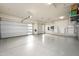 Spacious garage with epoxy flooring, insulated doors, storage solutions, and Tesla power wall installed for convenience at 18024 E Wolf Tree Ln, Rio Verde, AZ 85263