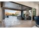 An outdoor living area with a fireplace, ceiling fan, and a view of the pool at 18024 E Wolf Tree Ln, Rio Verde, AZ 85263