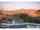 Stunning pool featuring a fountain with mountain views in the background at 18024 E Wolf Tree Ln, Rio Verde, AZ 85263