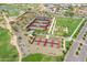 Aerial view of community tennis courts with lush green landscaping, walking paths, and mountain views at 18024 E Wolf Tree Ln, Rio Verde, AZ 85263