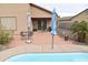 View of a charming brick patio with outdoor seating, bordered by a private pool at 1813 N Lewis Pl, Casa Grande, AZ 85122