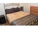 Bedroom with warm bedding, decorative headboard, and wood furniture at 1813 N Lewis Pl, Casa Grande, AZ 85122