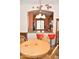 View of the kitchen from dining area with wood table and breakfast bar with bright red bar stools at 1813 N Lewis Pl, Casa Grande, AZ 85122