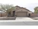 Charming single-story home with a two-car garage, desert landscaping, and a neutral color palette at 1813 N Lewis Pl, Casa Grande, AZ 85122