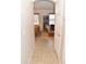 Hallway view showcasing a glimpse into living area with a library, rocking chair, and wood floors at 1813 N Lewis Pl, Casa Grande, AZ 85122