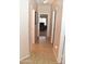 Hallway with tile flooring and multiple doorways at 1813 N Lewis Pl, Casa Grande, AZ 85122