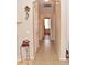 Hallway with neutral colors, a cuckoo clock, and tiled floors leads to various rooms at 1813 N Lewis Pl, Casa Grande, AZ 85122