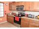 Kitchen with stainless steel appliances, granite counters and range with ceramic cooktop at 1813 N Lewis Pl, Casa Grande, AZ 85122