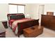 Comfortable main bedroom featuring a wood sleigh bed and matching dresser at 1813 N Lewis Pl, Casa Grande, AZ 85122