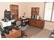 Home office with wood desk, chair, shelves, and carpet at 1813 N Lewis Pl, Casa Grande, AZ 85122