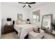 Well-lit bedroom features neutral décor, a ceiling fan, and a window at 18609 W Diana Ave, Waddell, AZ 85355