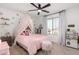 Cute bedroom featuring a pink bed, canopy, and decorative accents at 18609 W Diana Ave, Waddell, AZ 85355