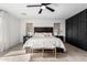 This primary bedroom has a neutral palette and stylish dark wood accents at 18609 W Diana Ave, Waddell, AZ 85355