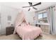 Bright bedroom featuring a ceiling fan, carpeted floors, and a cozy canopy bed at 18609 W Diana Ave, Waddell, AZ 85355