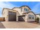 Exterior shot of a two-story house with a three-car garage at 18609 W Diana Ave, Waddell, AZ 85355