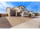 Stunning two-story home features a spacious driveway leading to a two-car garage and neutral color palette at 18609 W Diana Ave, Waddell, AZ 85355