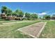 Dual horseshoe pits with lush grass offer an outdoor recreation for community members and their friends at 18609 W Diana Ave, Waddell, AZ 85355