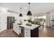 Bright kitchen with island, stainless steel appliances, and view of the dining area at 18609 W Diana Ave, Waddell, AZ 85355