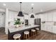 Modern kitchen features a large center island, stainless steel appliances, and white cabinetry at 18609 W Diana Ave, Waddell, AZ 85355