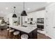 Modern kitchen with a center island, pendant lighting, and stainless steel appliances at 18609 W Diana Ave, Waddell, AZ 85355