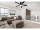 Comfortable living room featuring a sectional sofa, ottoman, and a neutral color scheme at 18609 W Diana Ave, Waddell, AZ 85355