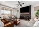 Bright living room features a fireplace with wood mantle and comfortable seating at 18609 W Diana Ave, Waddell, AZ 85355