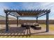 Backyard patio with comfortable seating under a pergola at 18609 W Diana Ave, Waddell, AZ 85355